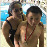 A special needs swimmer, and an equally enthusiastic volunteer.