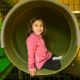 Girl in slide at Fort Mack, Child care room at Westport Weston Family YMCA