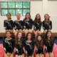 Gymnasts sitting in two rows