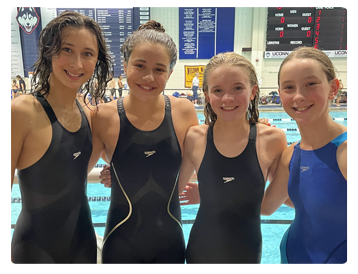 Smiling female members of the Water Rats swim team from Westport Weston YMCA