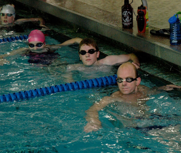 Olympic Gold Metal swimmer, Rowdy Gains, warms up with Westport Weston YMCA Water Rats senior swim team members in 2007