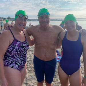 Swimmers smile and pose together after finishing Westport Weston YMCA 44th Point to Point at Compo Beach, Westport, CT.