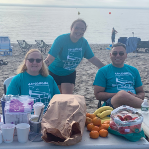 Volunteers welcoming swimmers with breakfast at Westport Weston YMCA 44th Point to Point at Compo Beach, Westport, CT.